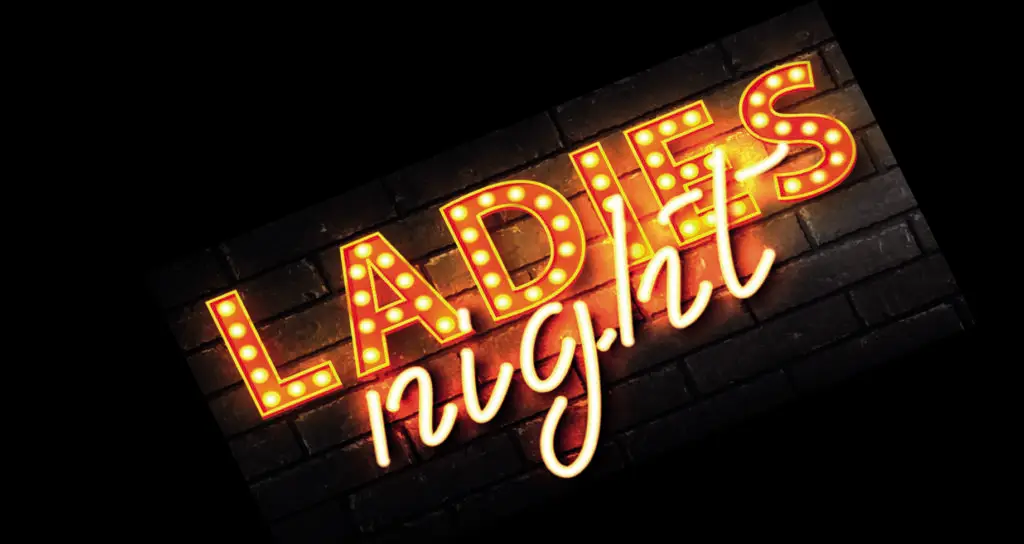 A sign that says ladies night lit up