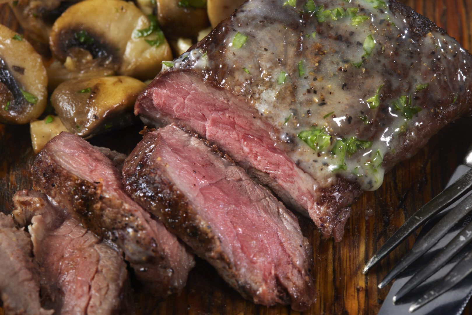 A close up of steak and potatoes on a plate